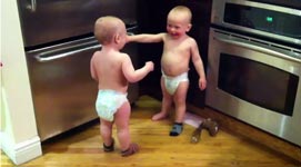 twin baby boys have a conversation